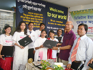 Education Minister Nurul Islam Nahid is handing over Computers to the Awardee of Digital Young Star Award as Chief Guest; Dr. M Helal is presiding over. (2010)